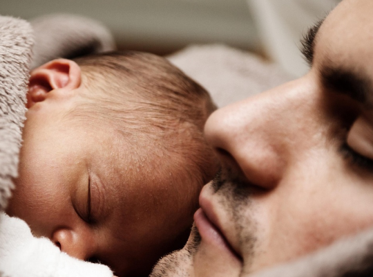 Father and baby sleeping
